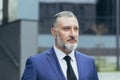 Portrait of serios senior businessman man with gray hair and brown hair in business suit with tie Royalty Free Stock Photo