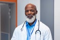 Portrait of serious african american senior male doctor in hospital corridor Royalty Free Stock Photo