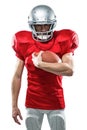 Portrait of serious American football player in red jersey holding ball Royalty Free Stock Photo