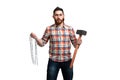 Serious bearded man in cap and checked shirt, holds hammer and chains in hands on white background Royalty Free Stock Photo