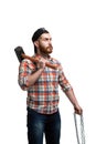 Serious bearded man in cap and checked shirt, holds sledgehammer and chains on white background Royalty Free Stock Photo