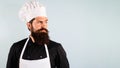 Portrait of serious bearded man in chef uniform. Professional chef, cook or baker looking away on copy space for Royalty Free Stock Photo