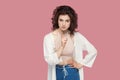 Portrait of serious beautiful brunette young woman with curly hairstyle in casual style standing, looking at camera with warning Royalty Free Stock Photo