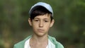 Portrait of a serious boy in a cap close-up looking at the camera, outdoors Royalty Free Stock Photo