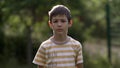 Portrait of a serious boy looking at the camera on nature Royalty Free Stock Photo