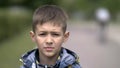 Portrait of a serious boy with a tence glance looking at the camera, close-up heavy face Royalty Free Stock Photo