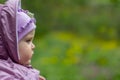 Portrait of serious brooding eleven month old baby girl on natural background Royalty Free Stock Photo