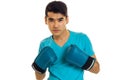 Portrait of serious brunette sports man practicing box in blue gloves isolated on white background Royalty Free Stock Photo