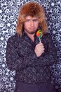 Portrait of serious business man in black shirt with patterns in a fur hat Royalty Free Stock Photo