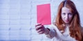 Portrait of serious business woman pointing red card as symbol of punishment and disqualification