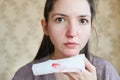 Portrait of serious with caucasian woman with nosebleed. Pensive woman with with a serious illness