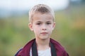 Portrait of a serious child boy outdoors Royalty Free Stock Photo