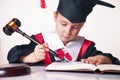 Portrait of serious child girl judge lawyer reads the penal code. Humorous photo.letter of law, strict law, justice concept