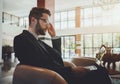 Businessman in the armchair with the laptop Royalty Free Stock Photo