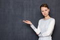 Portrait of serious concentrated girl pointing with hand at left Royalty Free Stock Photo