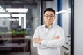 Portrait of serious confident asian man inside office at workplace, businessman in shirt with wrinkled hands and glasses Royalty Free Stock Photo