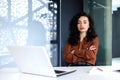 Portrait of serious and confident business woman, hispanic woman sitting looking at camera with arms crossed, female Royalty Free Stock Photo