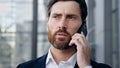 Portrait serious confident businessman talking on phone answering business call professional manager communicates with Royalty Free Stock Photo