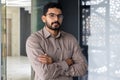 Portrait of serious confident hindu businessman, man in shirt thinking and looking at camera with crossed arms, mature Royalty Free Stock Photo