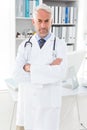 Portrait of a serious confident male doctor at medical office Royalty Free Stock Photo