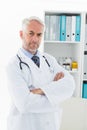 Portrait of a serious confident male doctor at medical office Royalty Free Stock Photo