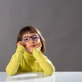 Portrait of serious daydreaming girl thinking with conscious education, studio