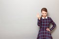 Portrait of serious discerning girl making money gesture with fingers Royalty Free Stock Photo