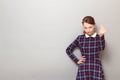 Portrait of serious discerning girl making money gesture with fingers Royalty Free Stock Photo