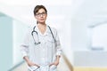 Portrait of serious doctor with stethoscope looking at camera.Medical physician doctor woman over blue clinic background Royalty Free Stock Photo