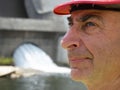 Portrait of a serious elderly male engineer in a helmet of a worker Royalty Free Stock Photo