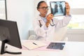 Portrait of serious female doctor looking at x-ray image Royalty Free Stock Photo