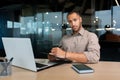 Portrait of serious and focused businessman, man looking thinking at camera writing and signing document inside office Royalty Free Stock Photo