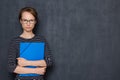 Portrait of serious focused girl with glasses, holding folders and pen Royalty Free Stock Photo