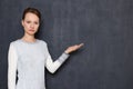 Portrait of serious focused girl pointing at copy space on right Royalty Free Stock Photo