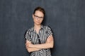 Portrait of serious focused woman with glasses, holding arms folded Royalty Free Stock Photo