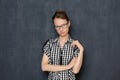 Portrait of serious focused woman with glasses, holding arms folded Royalty Free Stock Photo