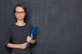 Portrait of serious focused woman holding folder and pen in hands Royalty Free Stock Photo