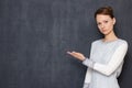 Portrait of serious focused woman pointing with hand at left Royalty Free Stock Photo