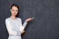 Portrait of serious focused woman pointing with hand at right Royalty Free Stock Photo