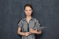 Portrait of serious focused young woman holding folder in hands Royalty Free Stock Photo