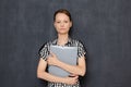 Portrait of serious focused young woman holding folder in hands Royalty Free Stock Photo