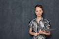 Portrait of serious focused young woman holding folder in hands Royalty Free Stock Photo