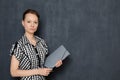 Portrait of serious focused young woman holding folder in hands Royalty Free Stock Photo