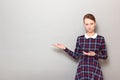 Portrait of serious girl pointing with both hands at copy space Royalty Free Stock Photo