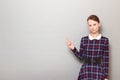Portrait of serious girl pointing with index finger at copy space Royalty Free Stock Photo