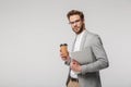 Portrait of serious handsome man posing with laptop and paper cup Royalty Free Stock Photo