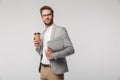 Portrait of serious handsome man posing with laptop and paper cup Royalty Free Stock Photo