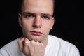 portrait of a serious handsome pensive guy on a black background Royalty Free Stock Photo