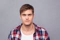 Portrait of serious handsome young man in checkered shirt Royalty Free Stock Photo