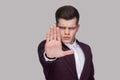 Portrait of serious handsome young man in violet suit and white Royalty Free Stock Photo